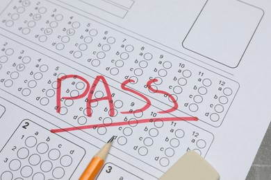 Photo of Answer sheet with word Pass, eraser and pencil on table, closeup. Student passing exam