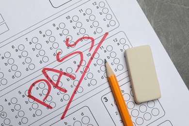 Photo of Answer sheet with word Pass, eraser and pencil on gray table, flat lay. Student passing exam