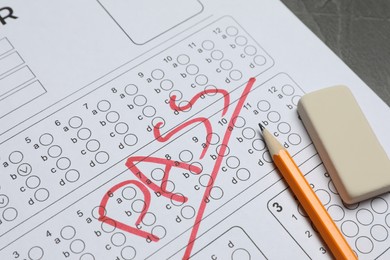 Photo of Answer sheet with word Pass, eraser and pencil on table, closeup. Student passing exam