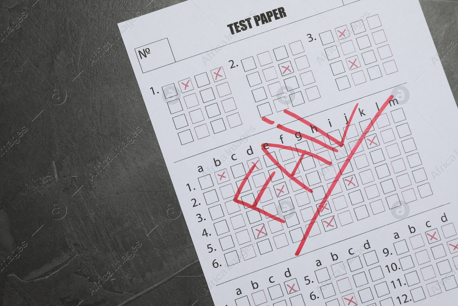 Answer sheet with word Fail on gray textured table, top view. Student passing exam Photo of Answer sheet with word Fail on gray textured table, top view. Student passing exam