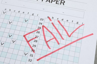 Photo of Word Fail written with red marker on answer sheet, closeup. Student passing exam