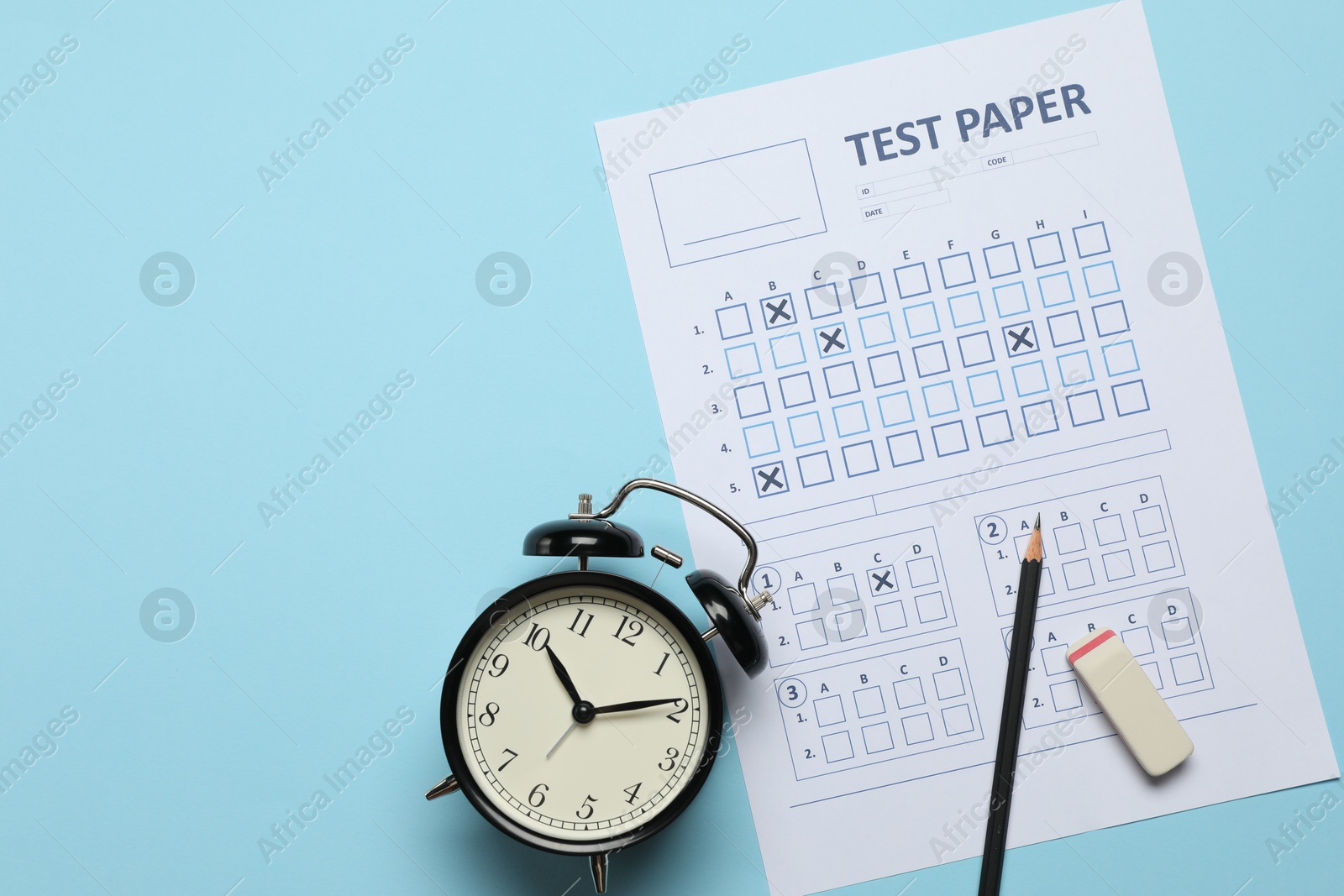 Student passing exam. Answer sheet, alarm clock, pencil and eraser on light blue background, flat lay. Space for text Photo of Student passing exam. Answer sheet, alarm clock, pencil and eraser on light blue background, flat lay. Space for text