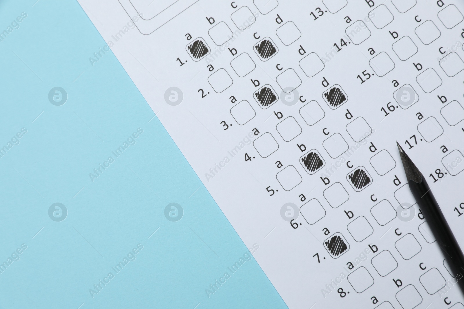 Answer sheet and pencil on light blue background, flat lay. Student passing exam Photo of Answer sheet and pencil on light blue background, flat lay. Student passing exam