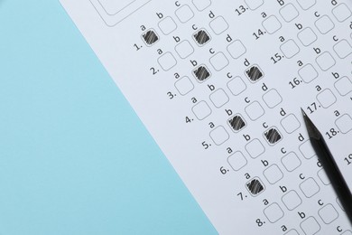 Photo of Answer sheet and pencil on light blue background, flat lay. Student passing exam