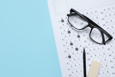 Photo of Student passing exam. Answer sheet, glasses, pencil and eraser on light blue background, flat lay. Space for text