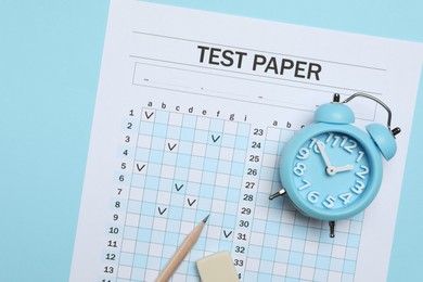 Photo of Answer sheet, alarm clock, pencil and eraser on light blue background, flat lay. Student passing exam