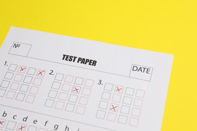 Photo of Answer sheet on yellow background, closeup. Student passing exam