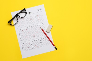 Photo of Student passing exam. Answer sheet, glasses, pencil and eraser on yellow background, flat lay. Space for text