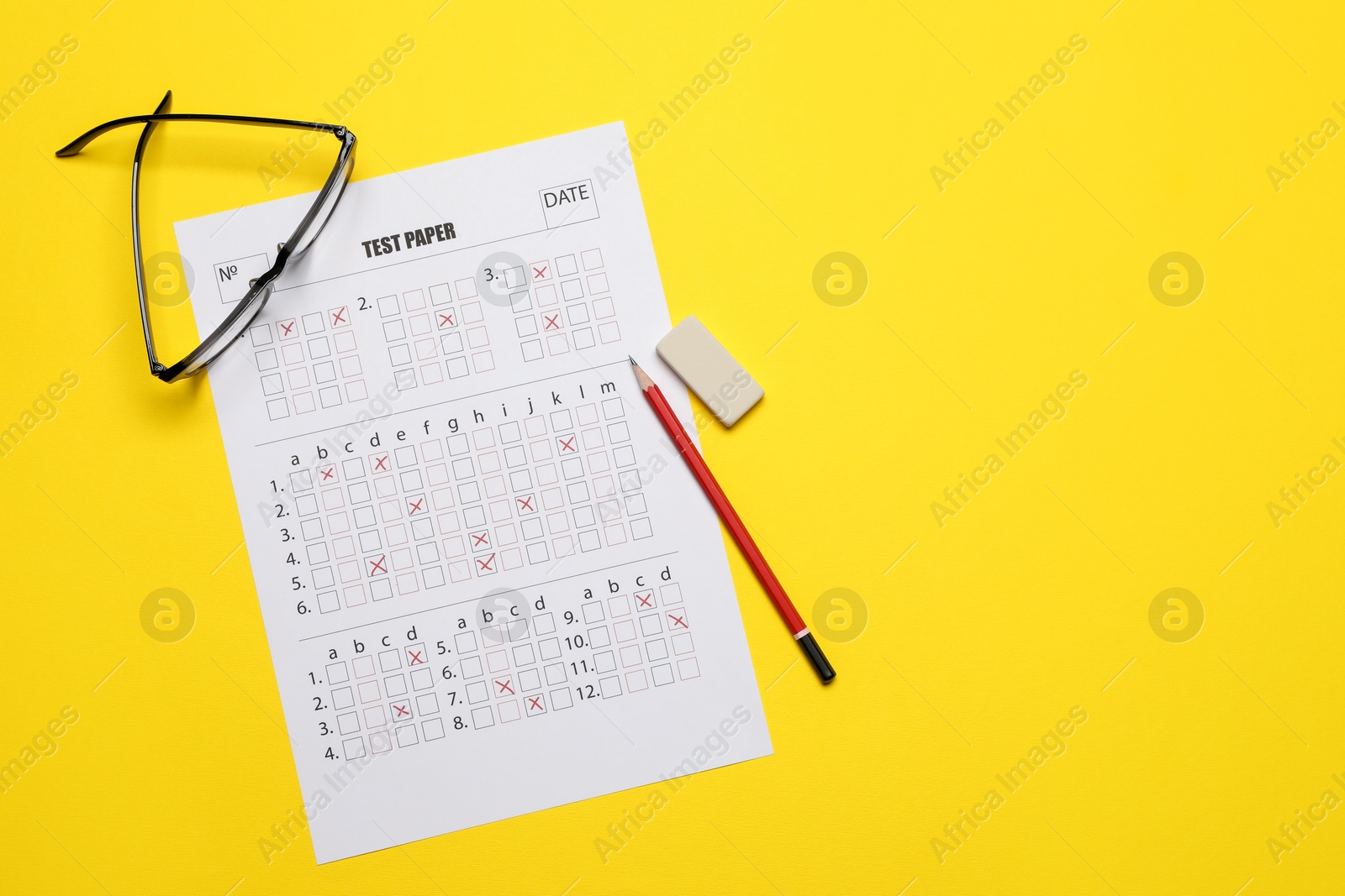 Student passing exam. Answer sheet, glasses, pencil and eraser on yellow background, flat lay. Space for text Photo of Student passing exam. Answer sheet, glasses, pencil and eraser on yellow background, flat lay. Space for text