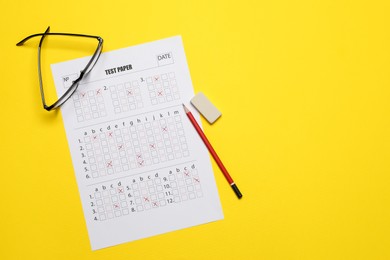 Photo of Student passing exam. Answer sheet, glasses, pencil and eraser on yellow background, flat lay. Space for text