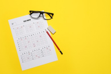 Photo of Student passing exam. Answer sheet, glasses, pencil and eraser on yellow background, flat lay. Space for text