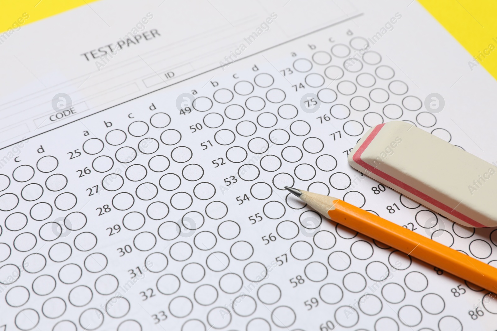 Photo of Answer sheet, pencil and eraser on table, closeup. Student passing exam