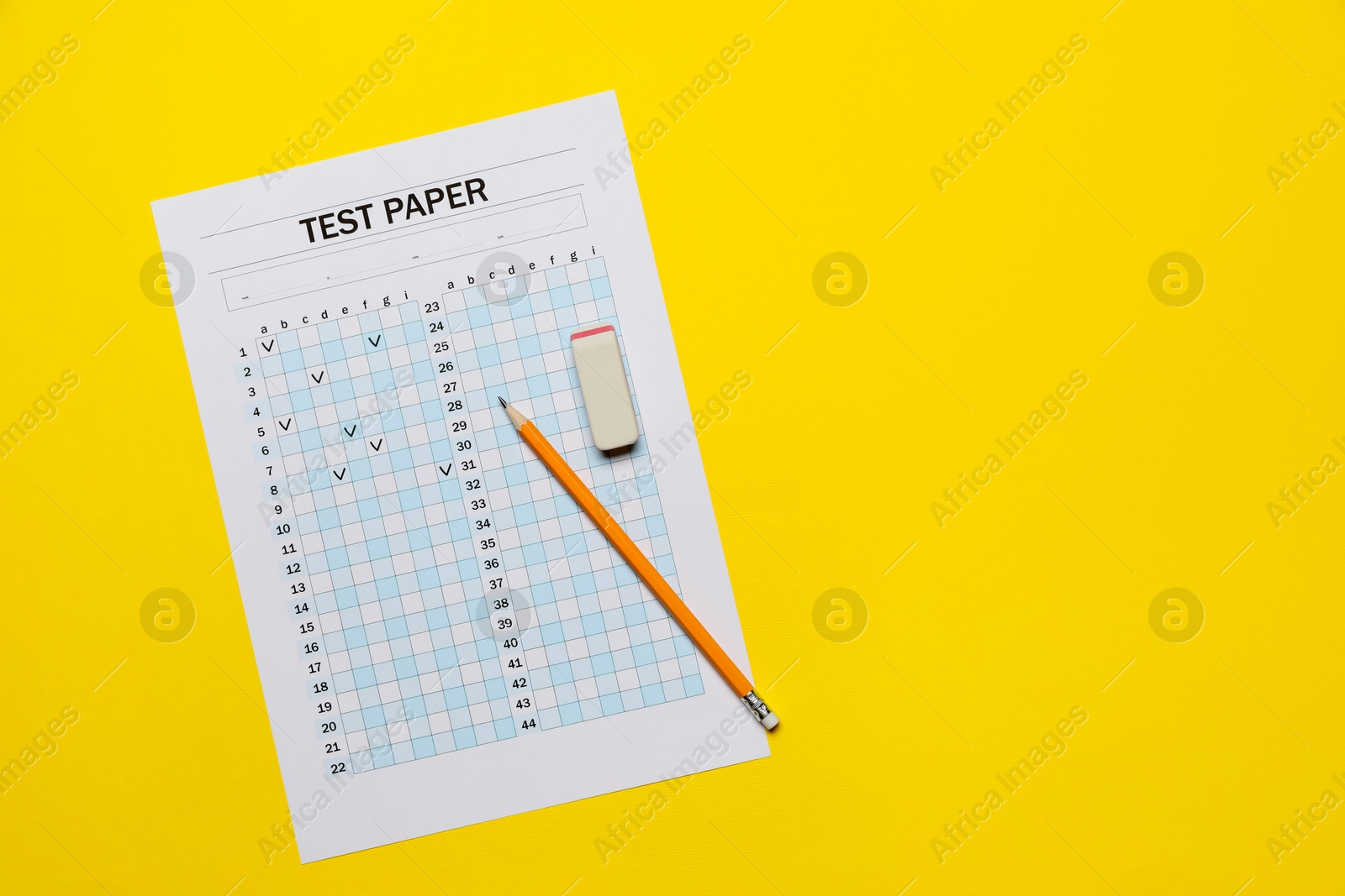 Photo of Student passing exam. Answer sheet, pencil and eraser on yellow background, flat lay. Space for text