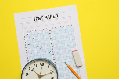 Photo of Answer sheet, alarm clock, pencil and eraser on yellow background, flat lay. Student passing exam