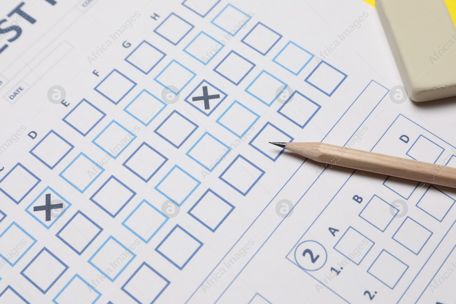 Photo of Answer sheet, pencil and eraser, closeup. Student passing exam