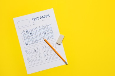 Photo of Student passing exam. Answer sheet, pencil and eraser on yellow background, flat lay. Space for text