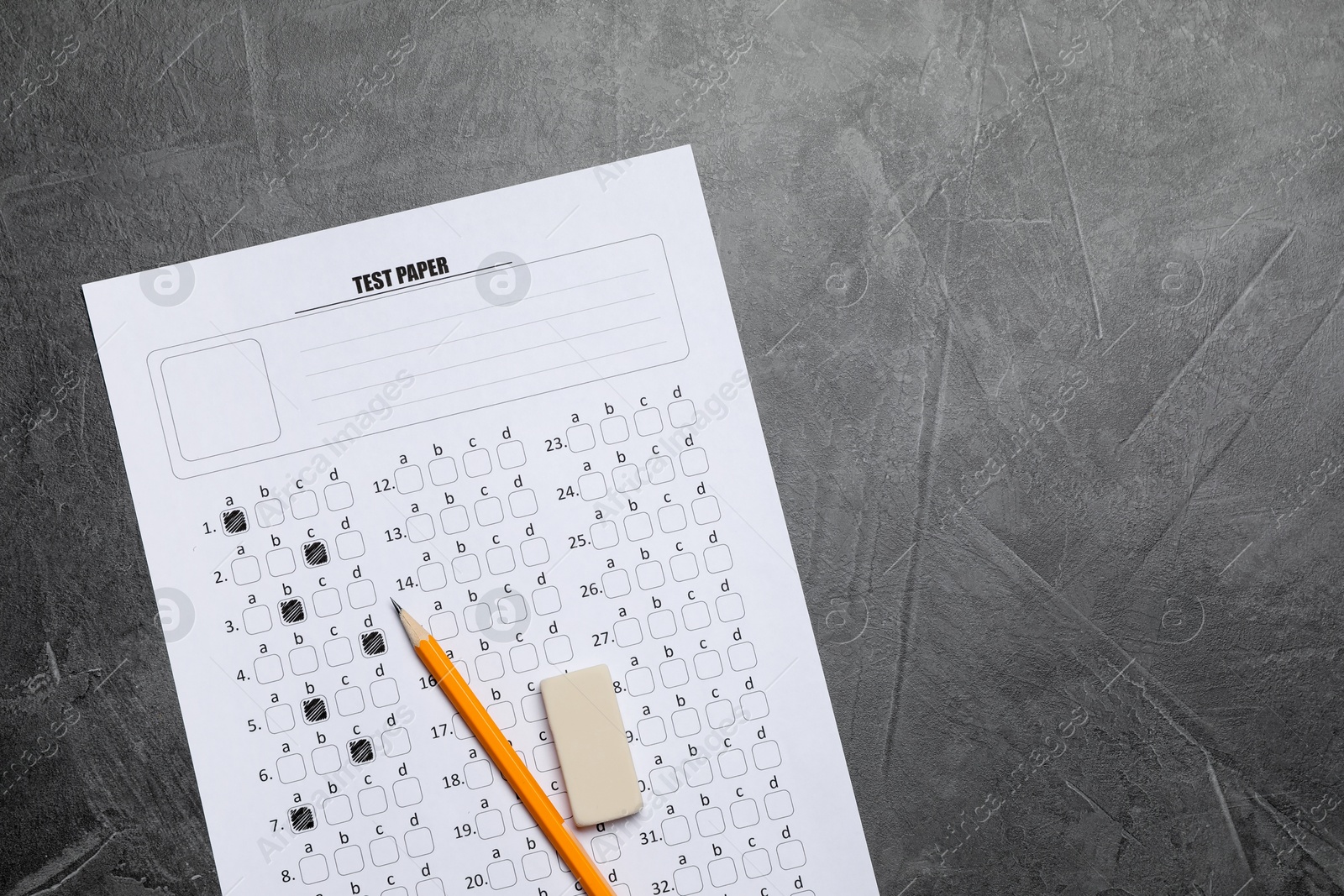 Photo of Student passing exam. Answer sheet, pencil and eraser on gray textured table, flat lay. Space for text