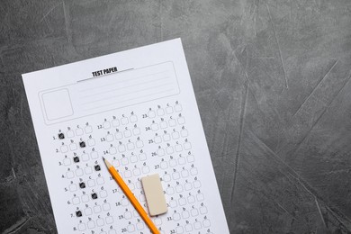 Photo of Student passing exam. Answer sheet, pencil and eraser on gray textured table, flat lay. Space for text