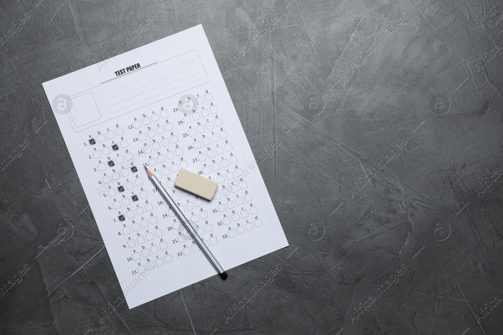 Photo of Student passing exam. Answer sheet, pencil and eraser on gray textured table, flat lay. Space for text