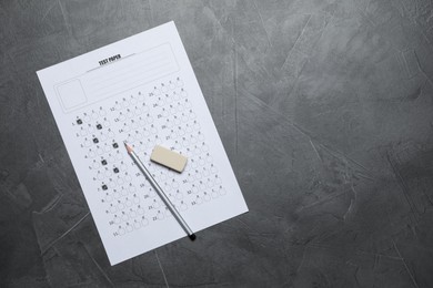Photo of Student passing exam. Answer sheet, pencil and eraser on gray textured table, flat lay. Space for text