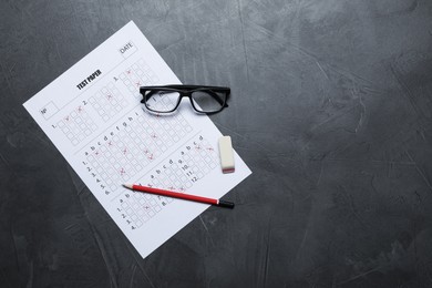 Photo of Student passing exam. Answer sheet, glasses, pencil and eraser on gray textured table, flat lay. Space for text