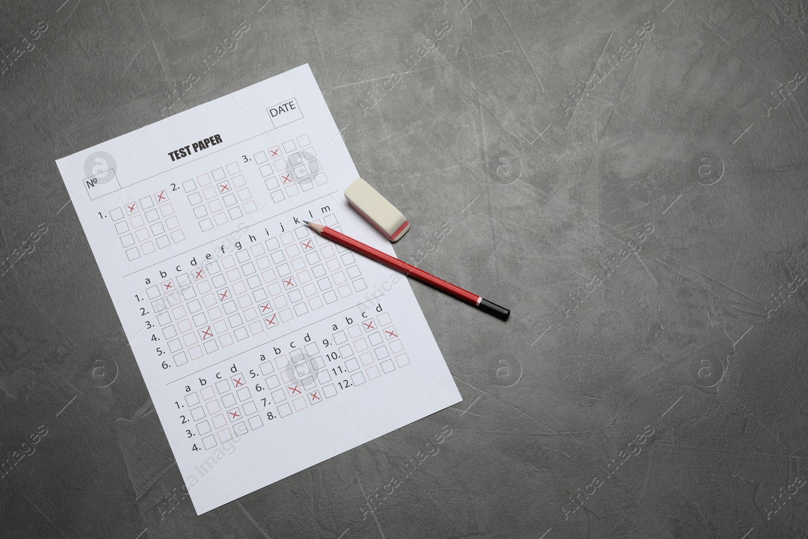 Student passing exam. Answer sheet, pencil and eraser on gray textured table, flat lay. Space for text Photo of Student passing exam. Answer sheet, pencil and eraser on gray textured table, flat lay. Space for text
