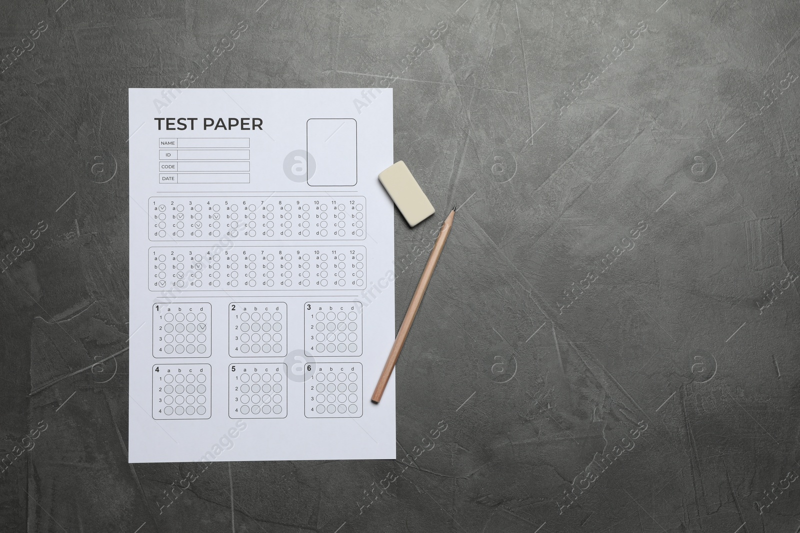 Student passing exam. Answer sheet, pencil and eraser on gray textured table, flat lay. Space for text Photo of Student passing exam. Answer sheet, pencil and eraser on gray textured table, flat lay. Space for text
