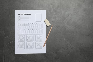Photo of Student passing exam. Answer sheet, pencil and eraser on gray textured table, flat lay. Space for text
