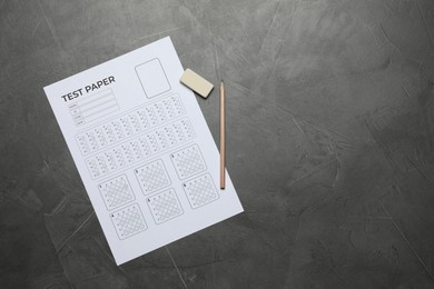 Photo of Student passing exam. Answer sheet, pencil and eraser on gray textured table, flat lay. Space for text