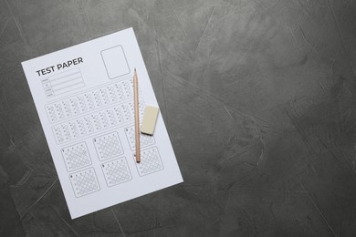 Photo of Student passing exam. Answer sheet, pencil and eraser on gray textured table, flat lay. Space for text