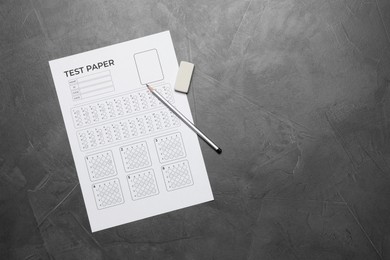 Photo of Student passing exam. Answer sheet, pencil and eraser on gray textured table, flat lay. Space for text