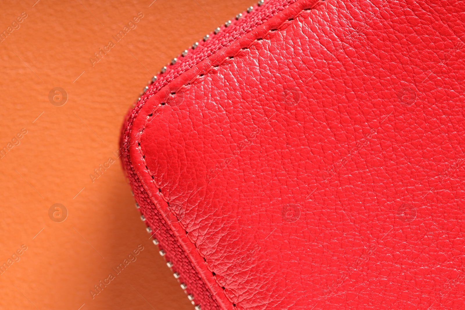 Red leather bag on color surface, top view Photo of Red leather bag on color surface, top view