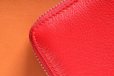 Photo of Red leather bag on color surface, top view