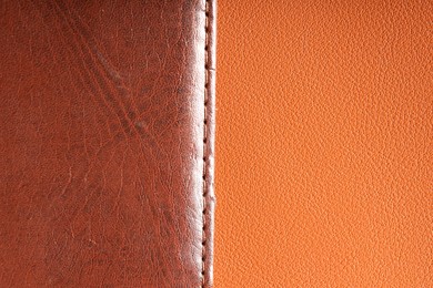 Photo of Brown natural leather with seam on color surface, top view