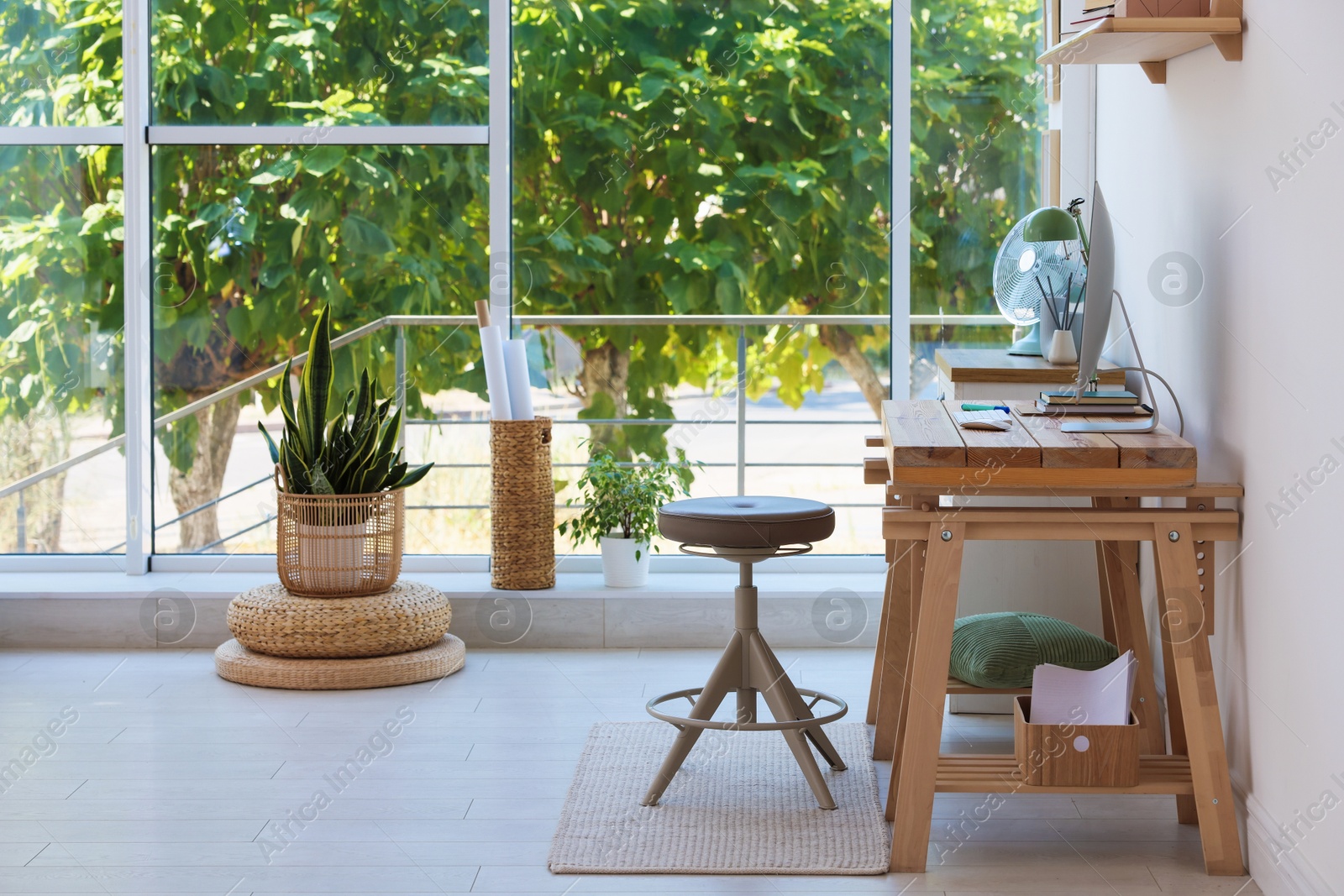 Photo of Home workspace. Modern computer and stationery on wooden desk near window indoors