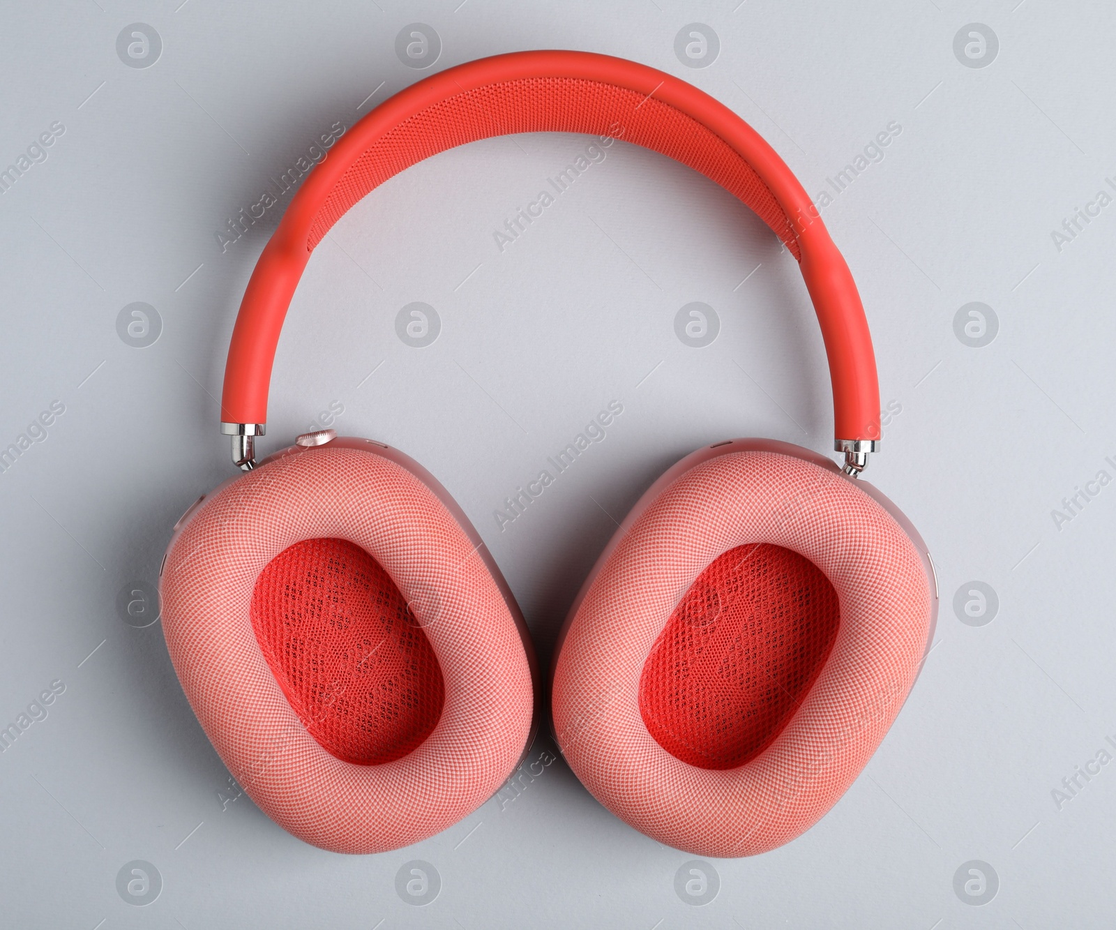 Pair of stylish pink headphones on light grey background, top view Photo of Pair of stylish pink headphones on light grey background, top view