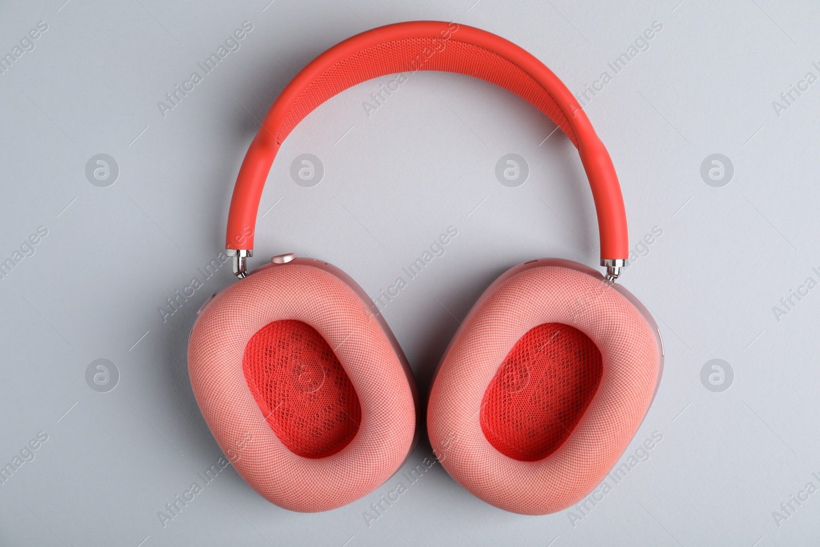 Pair of stylish pink headphones on light grey background, top view Photo of Pair of stylish pink headphones on light grey background, top view