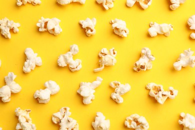 Photo of Tasty popcorn on yellow background, flat lay