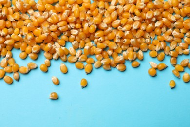 Photo of Dry kernels on light blue background, flat lay. Space for text