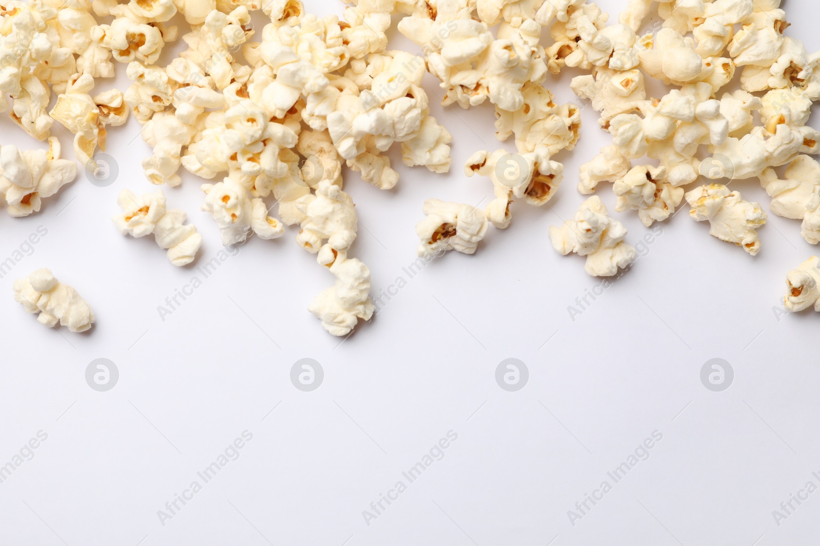 Tasty popcorn on white background, flat lay. Space for text Photo of Tasty popcorn on white background, flat lay. Space for text