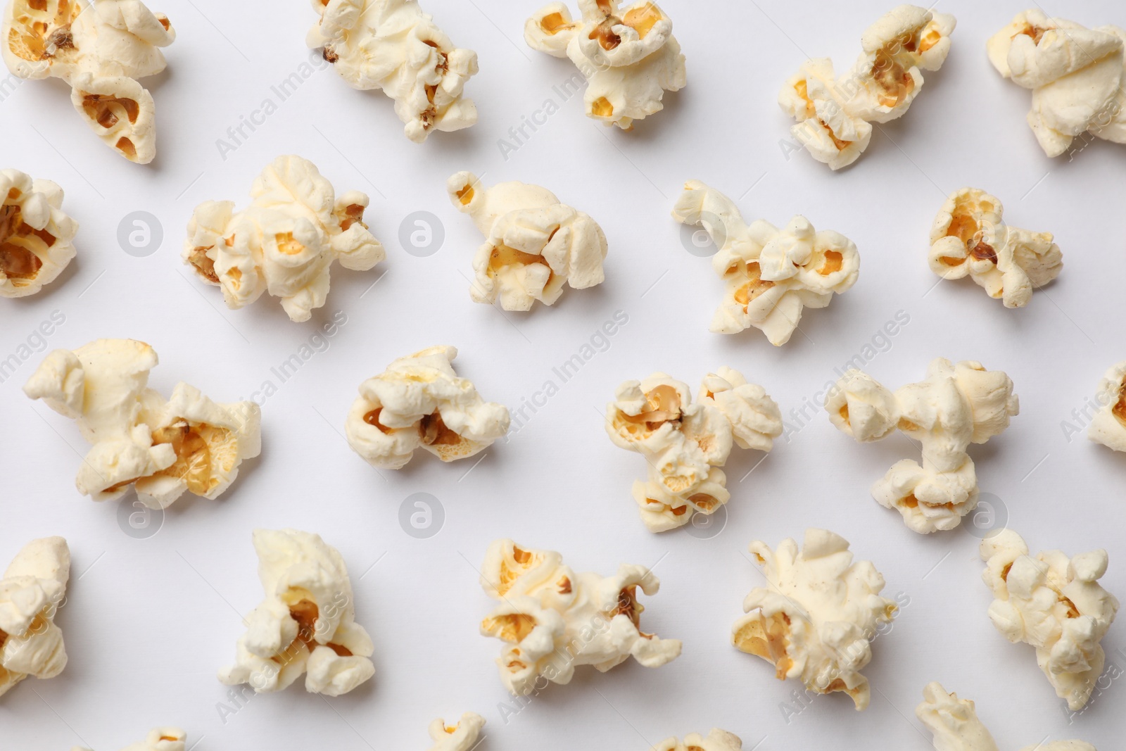 Tasty popcorn on white background, flat lay Photo of Tasty popcorn on white background, flat lay