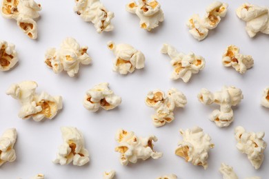 Photo of Tasty popcorn on white background, flat lay