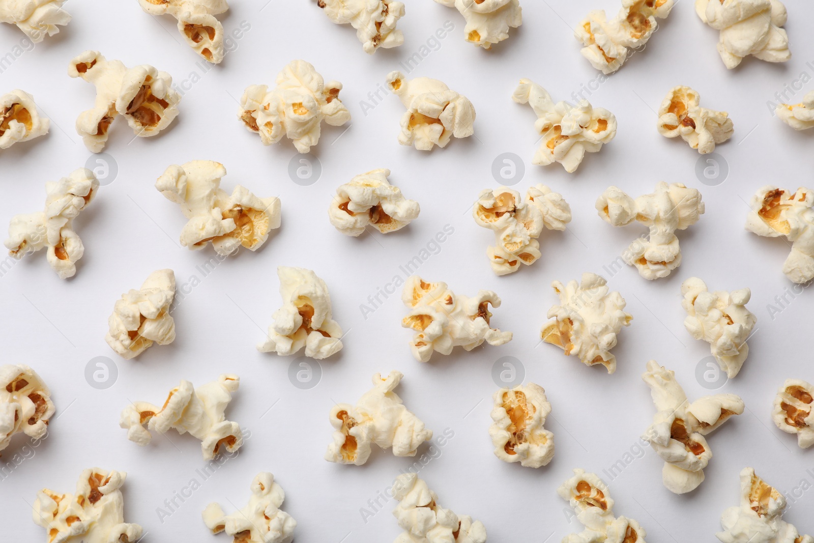 Photo of Tasty popcorn on white background, flat lay