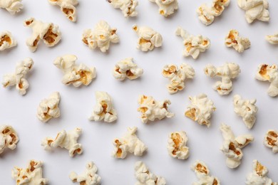 Photo of Tasty popcorn on white background, flat lay