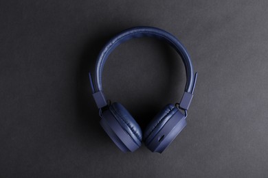Photo of Pair of stylish blue headphones on black background, top view