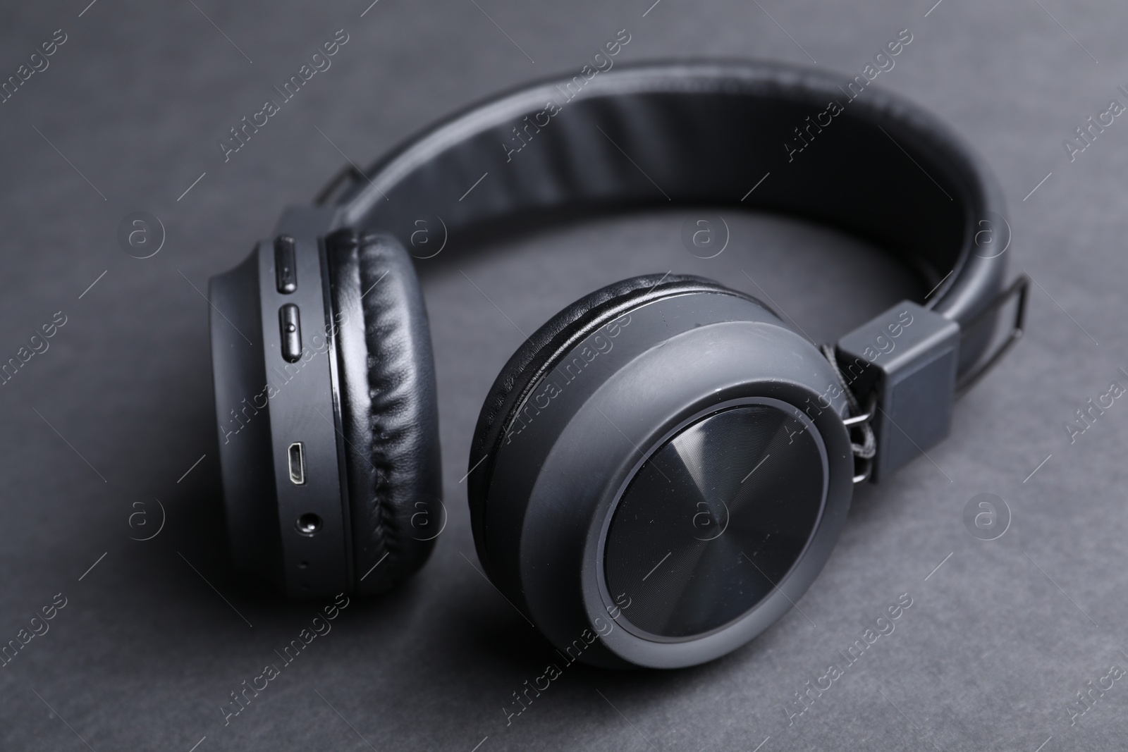 Pair of stylish headphones on black background, closeup Photo of Pair of stylish headphones on black background, closeup