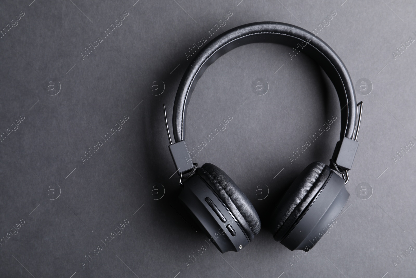 Pair of stylish headphones on black background, top view. Space for text Photo of Pair of stylish headphones on black background, top view. Space for text