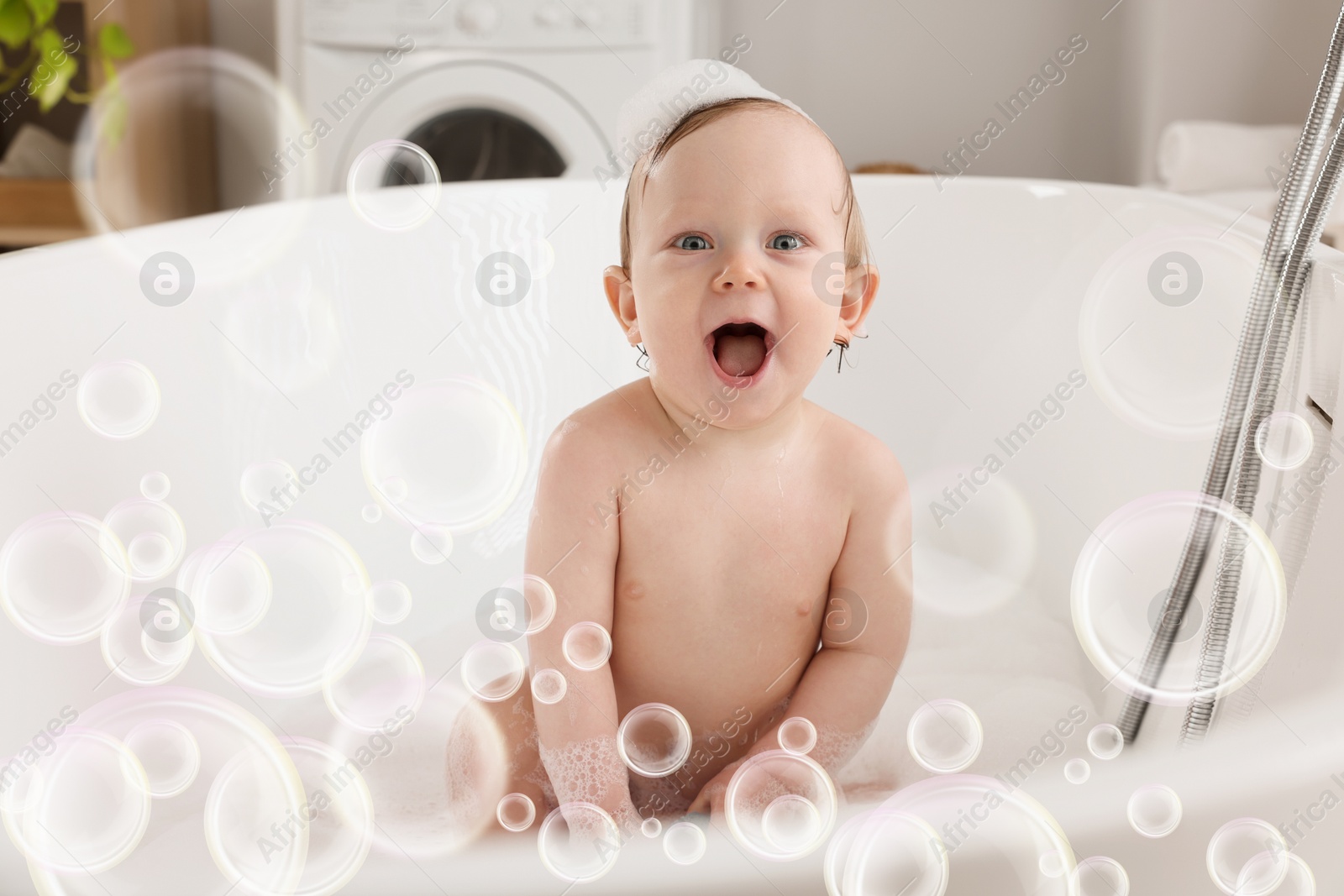 Cute little baby taking bath at home. Soap bubbles in air Image of Cute little baby taking bath at home. Soap bubbles in air