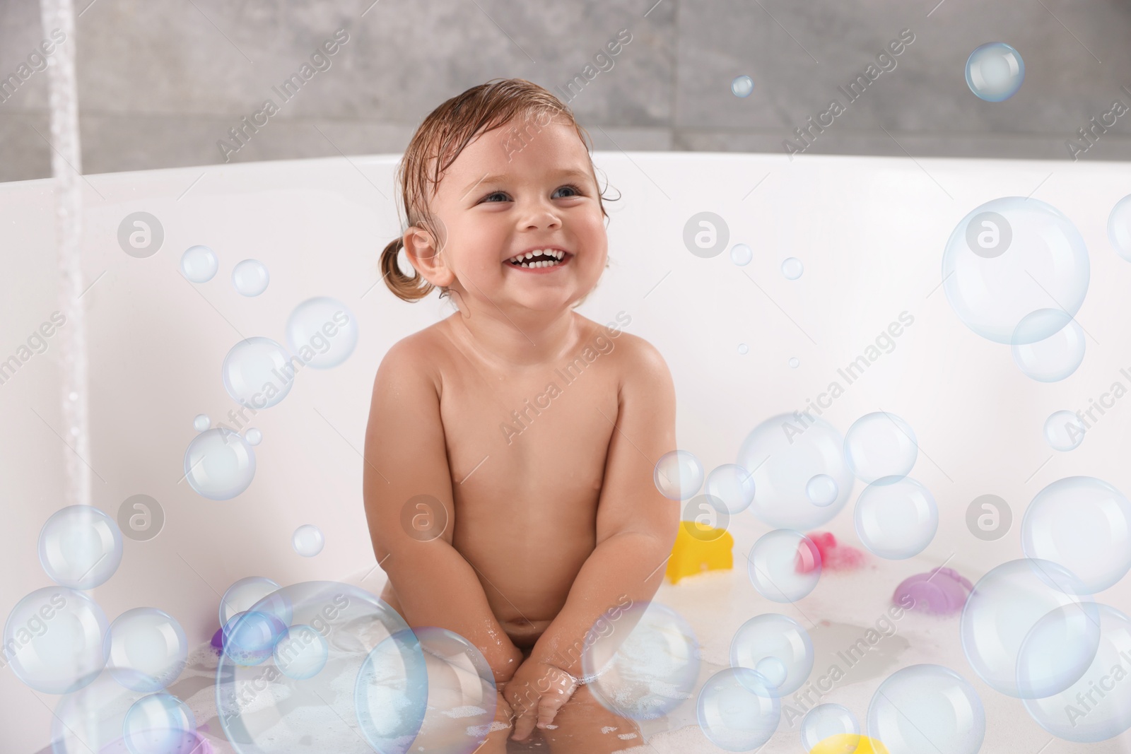 Cute little baby taking bath at home. Soap bubbles in air Image of Cute little baby taking bath at home. Soap bubbles in air