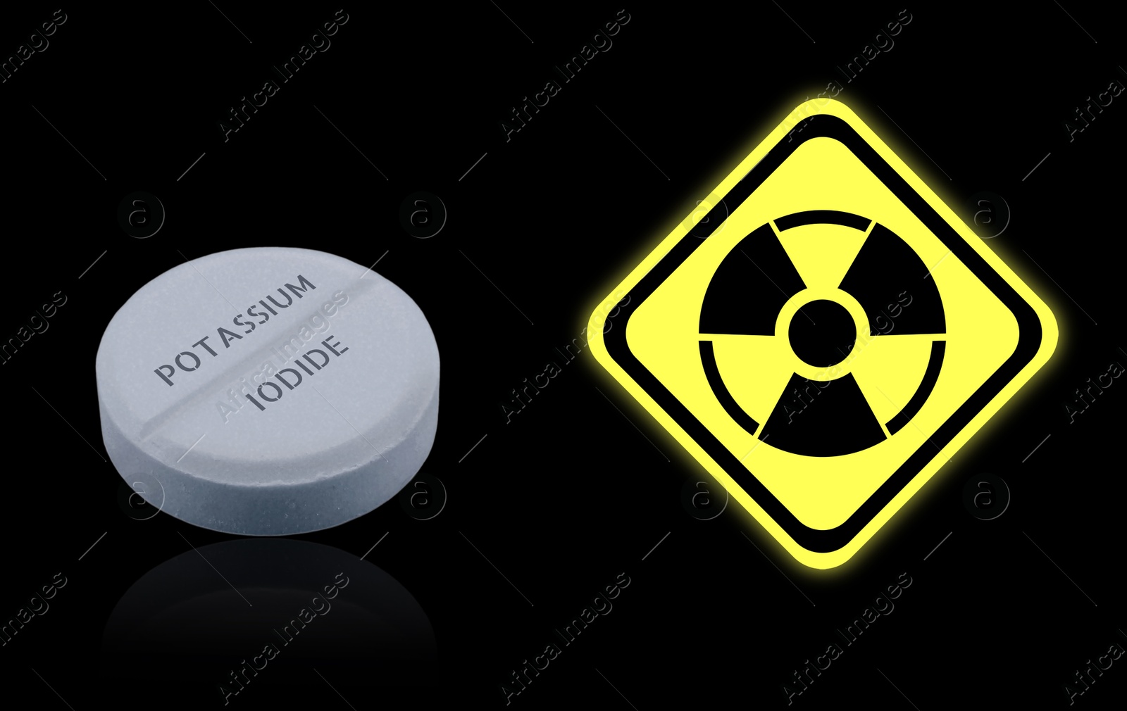 Potassium iodide pill and warning sign on black background. Iodine consumption during radioactive contamination Image of Potassium iodide pill and warning sign on black background. Iodine consumption during radioactive contamination